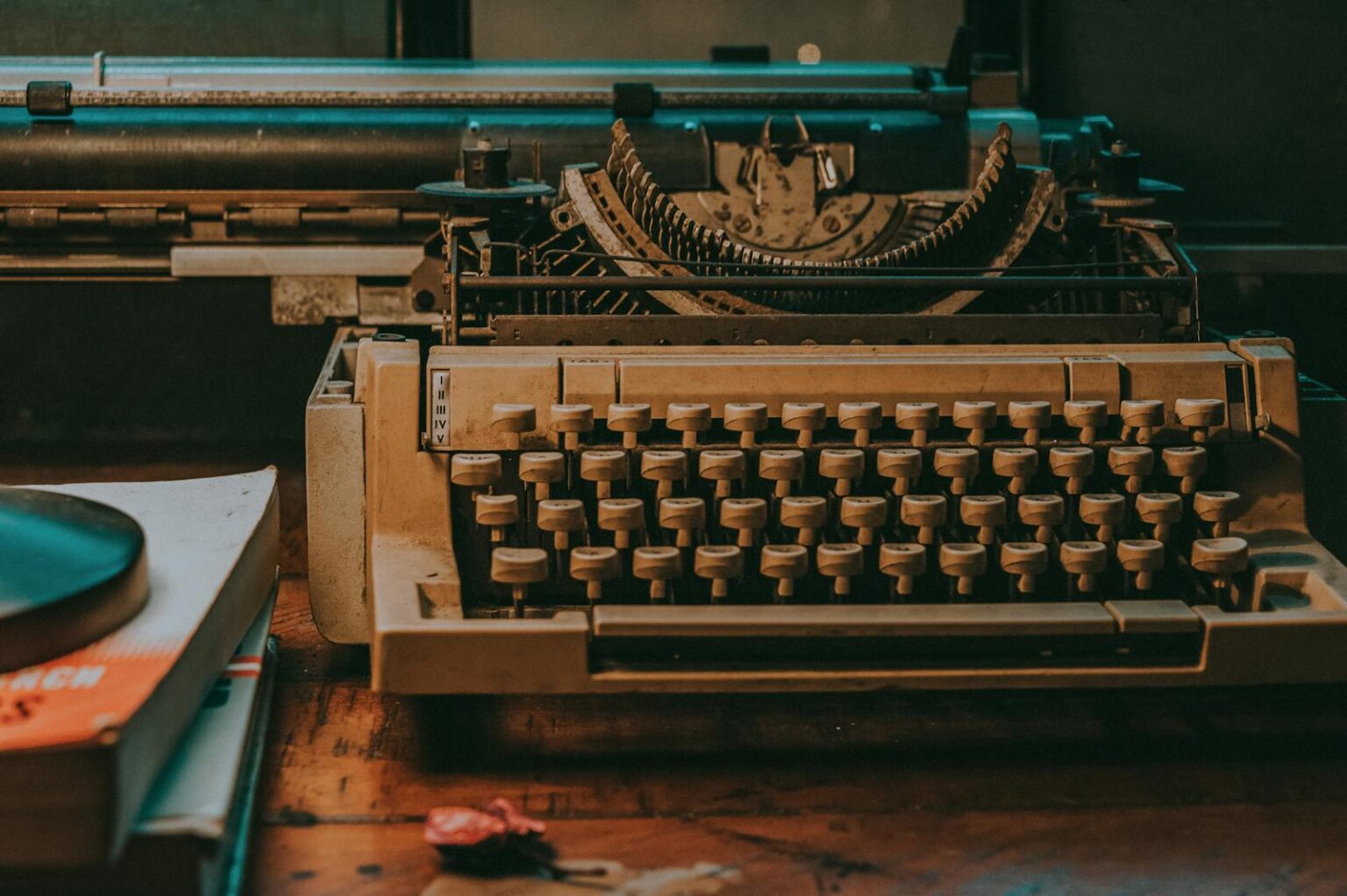 Close-up of a vintage typewriter on a wooden desk with classic design elements.